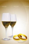 Wine Glasses next to Gold Wedding Rings